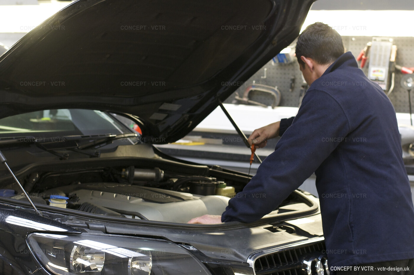 A CSC Automotive technician working under a bonnet